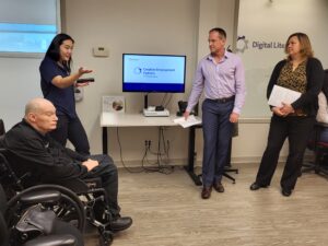 National Program Manager Patty Lavakittichaiyant presenting the Creative Employment Options program, while Gary Birch, Wayne Ackerman, and Elsa Chu Del Aguila listen.