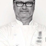 WorkBC Assistive Technology Services participant John wearing a chef coat.