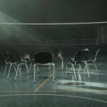 A circle of chairs in a gymnasium.