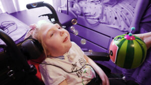 a child with a disability using an adapted bubble blower