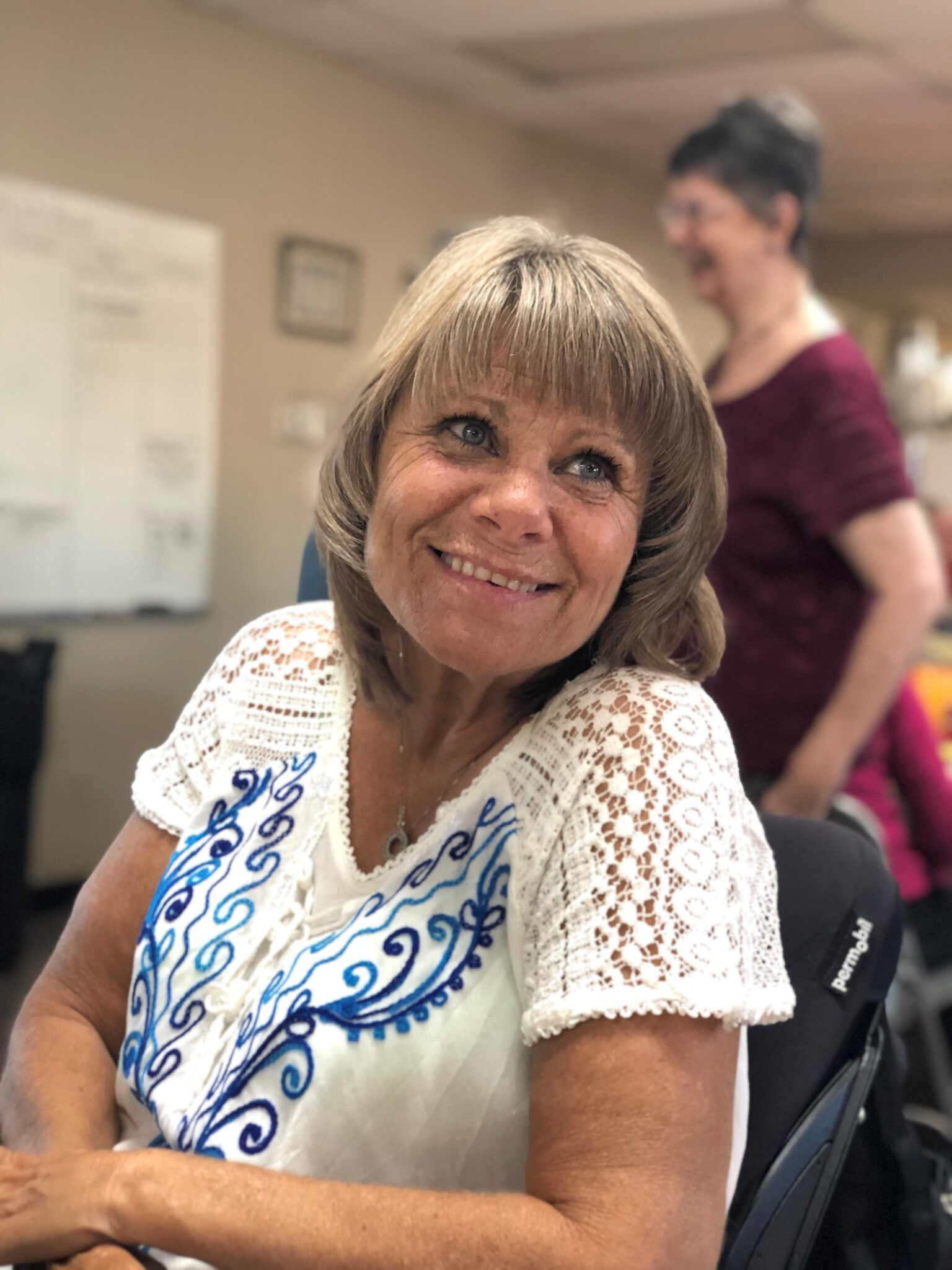 Lisa smiling in her wheelchair.