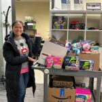 Kim with a cart of adapted toys.