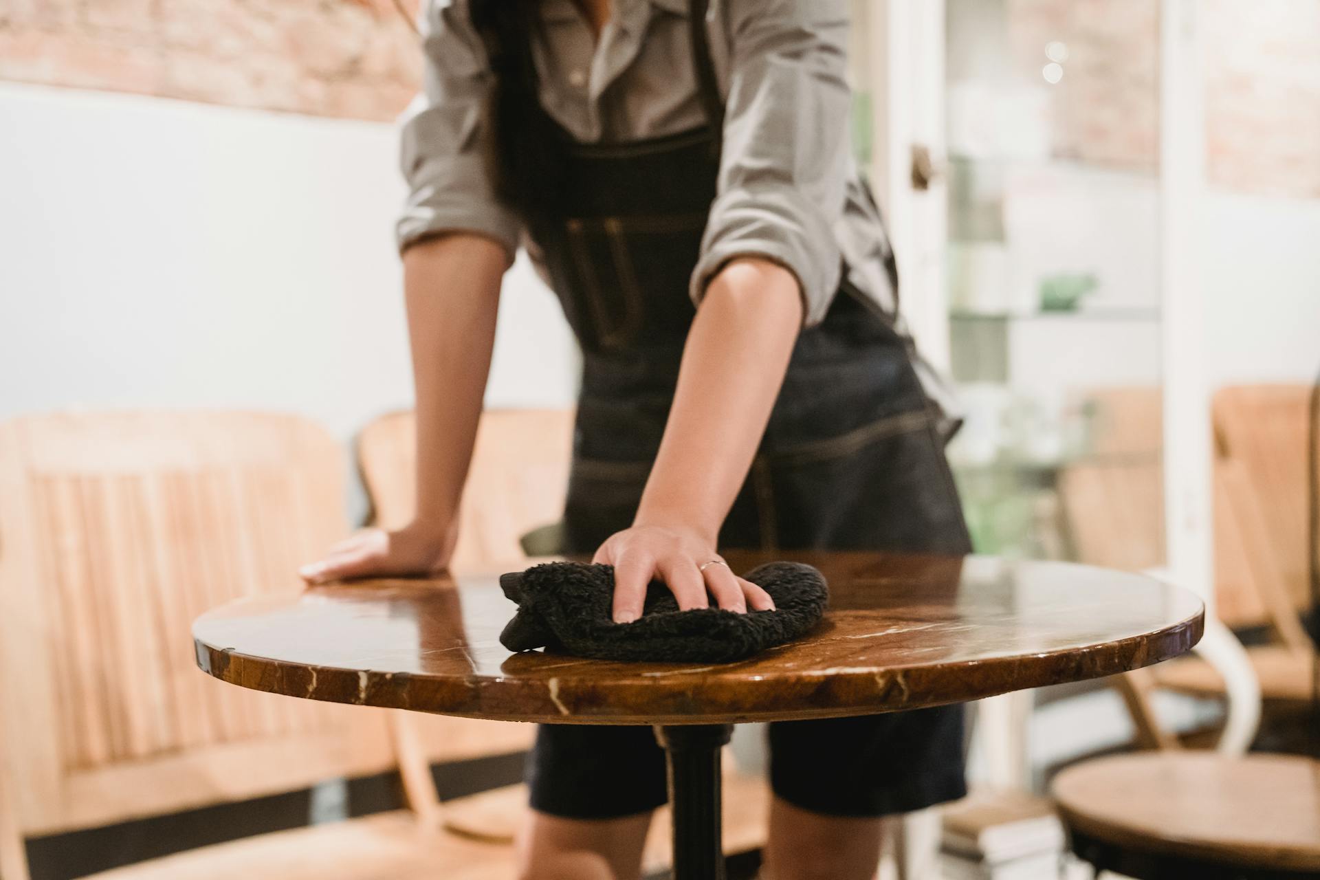 A server cleans a table.