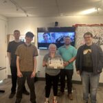 Empower3D participants with Nikki and Brad, who are holding a cake.