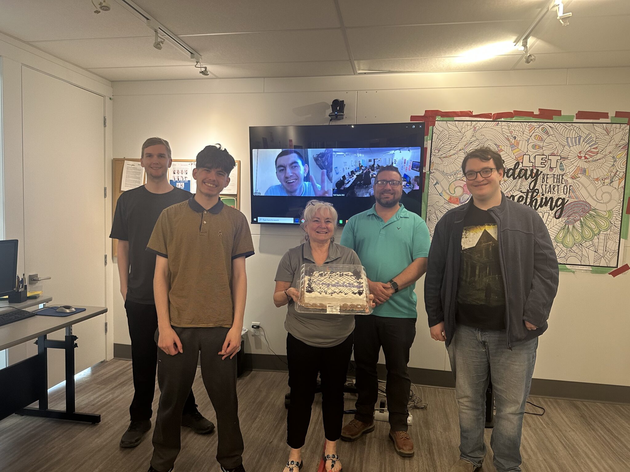 Empower3D participants with Nikki and Brad, who are holding a cake.