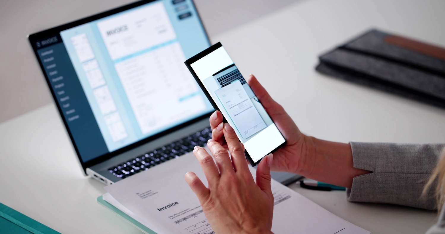 A person uses a phone to scan a document.