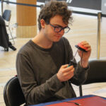 Jaxon uses a screwdriver to work on an Interact Switch.