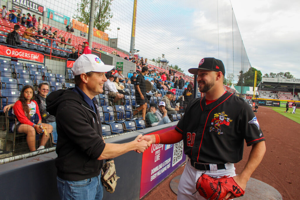 Justin shakes hands with Vancouver Canadians pitcher Chay Yeager.