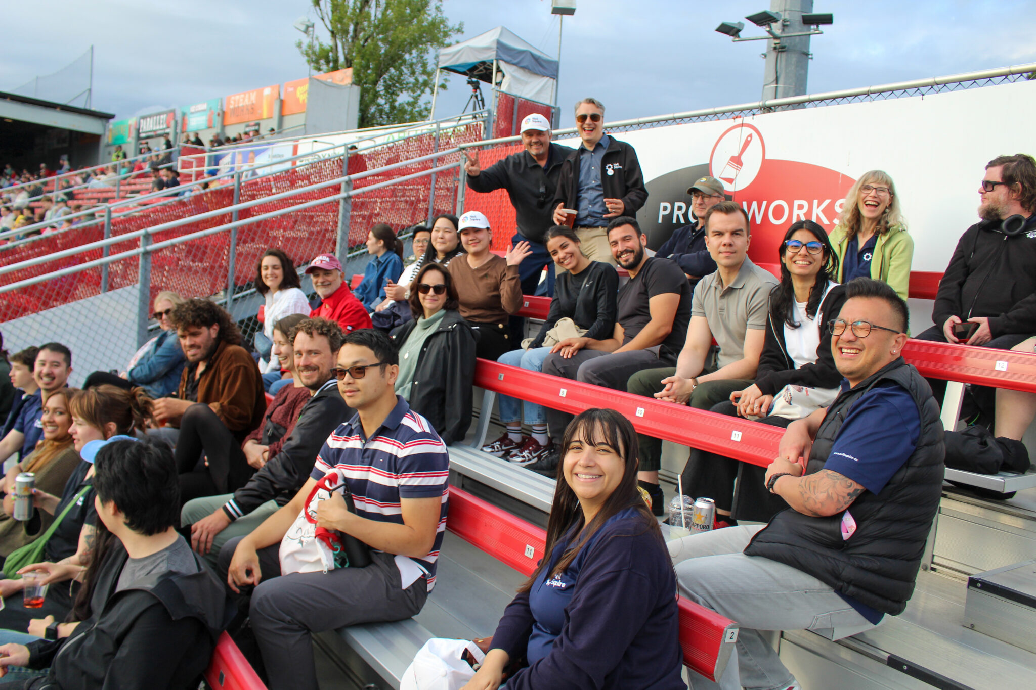 Neil Squire staff and friends sit in the stands.