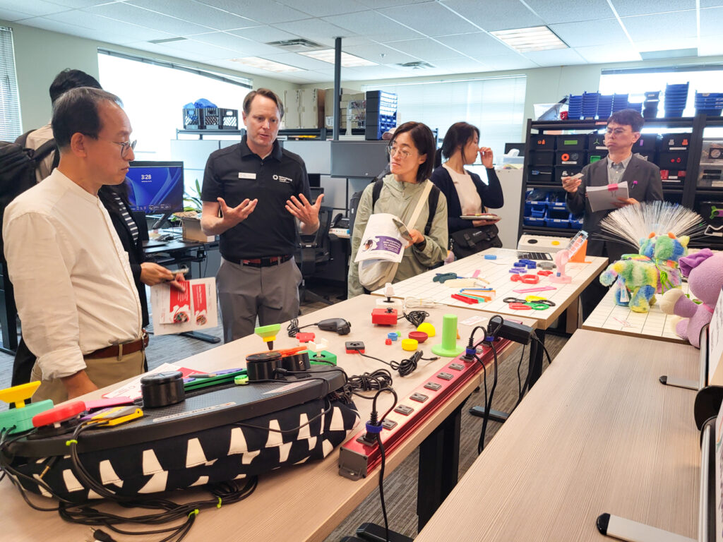 Justin gives the delegation a demonstration of our Makers Making Change program and 3D printed assistive technology.