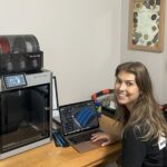Hannah working on a print on her 3D printer.