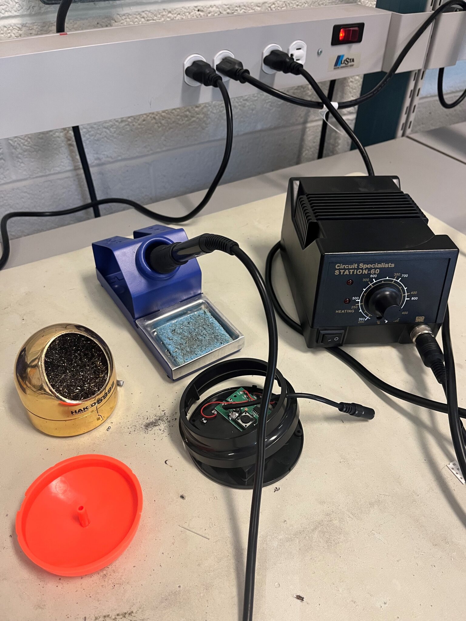 A soldering station with a disassembled switch.