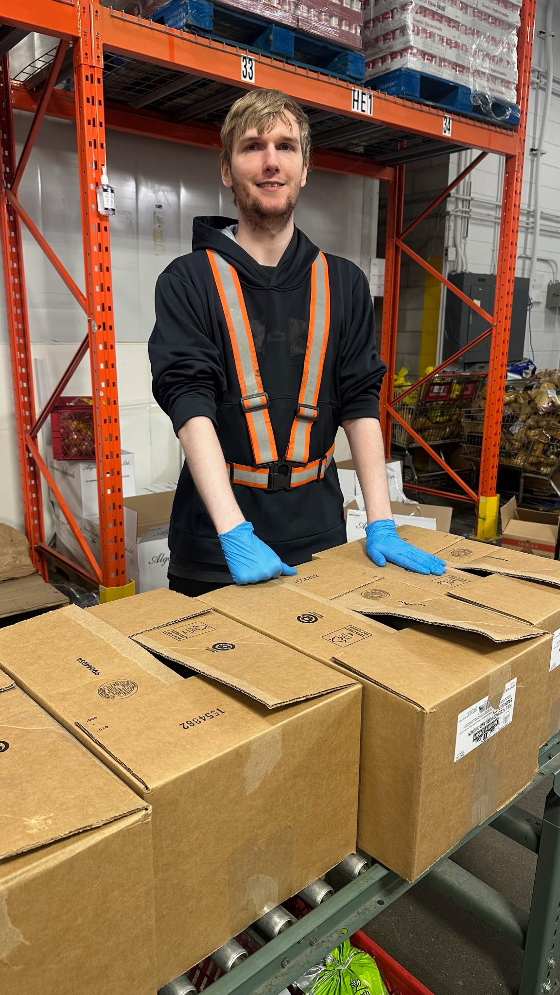 Gregory, at work, handling boxes.