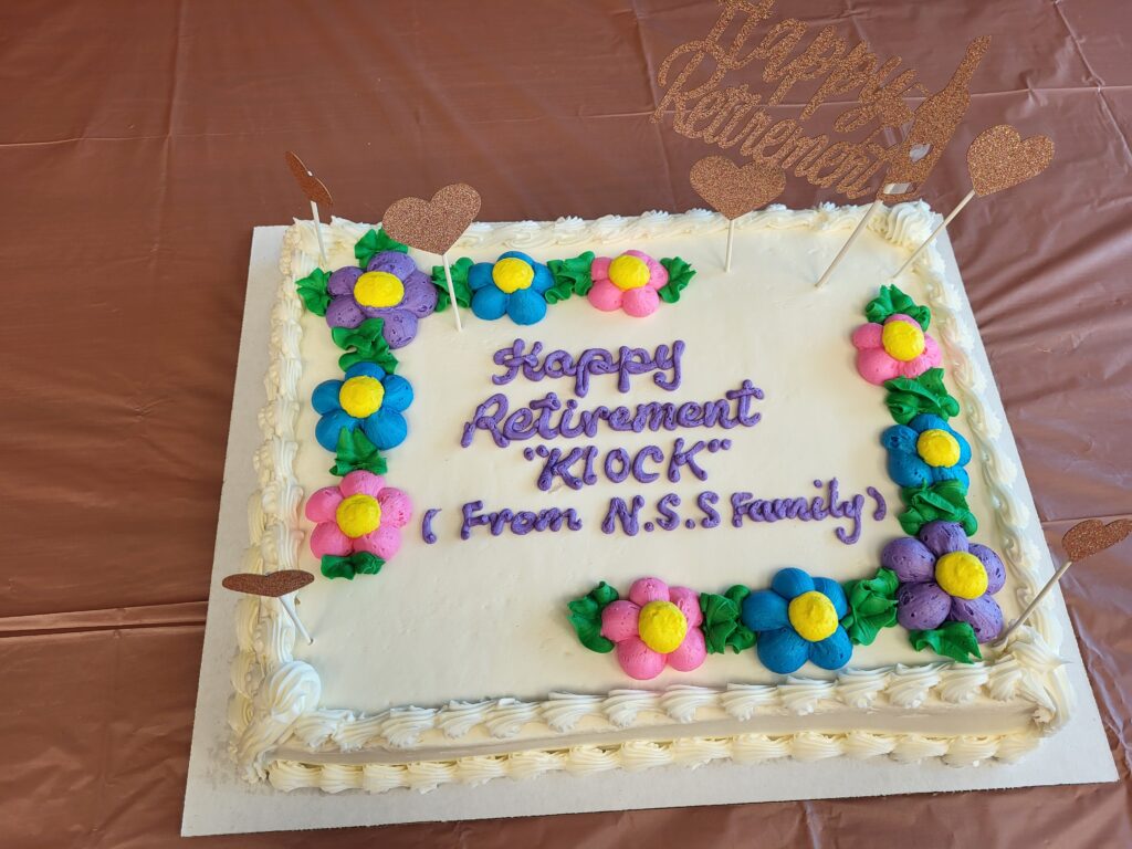 A cake with the text, "Happy Retirement Kiock (from NSS family)."