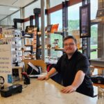 Creative Employment Options participant Tyler at work at the museum gift shop.