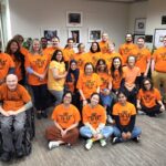 Burnaby office staff wearing orange shirts.