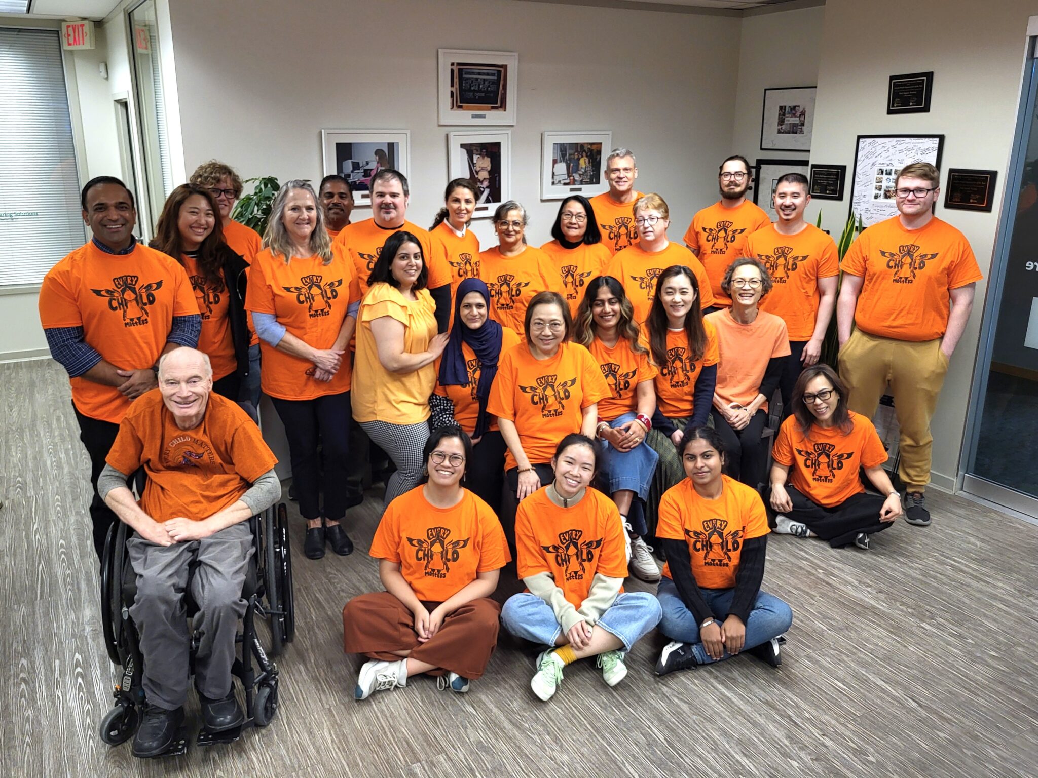 Burnaby office staff wearing orange shirts.