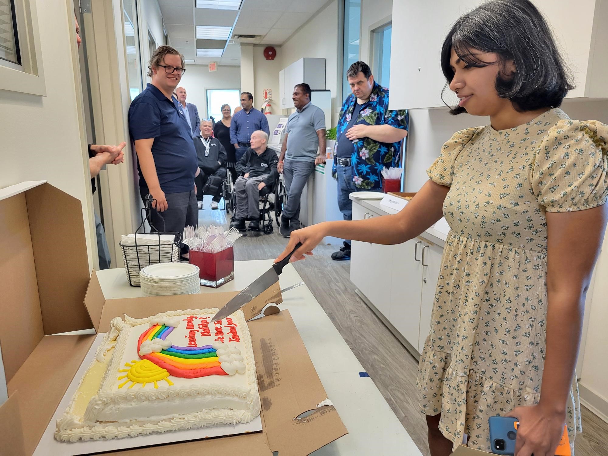 Khatidja cutting a cake at the party.