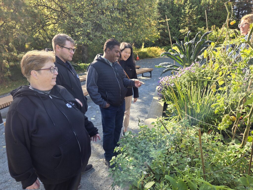 Neil Squire staff tour the Disabled Independent Gardeners Association's accessible garden.