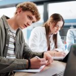 Youth studying together at a round table.