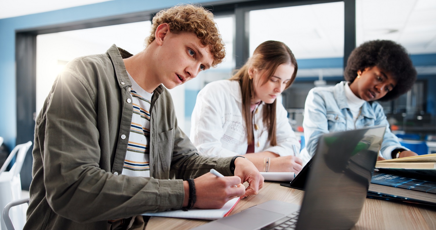 Youth studying together at a round table.