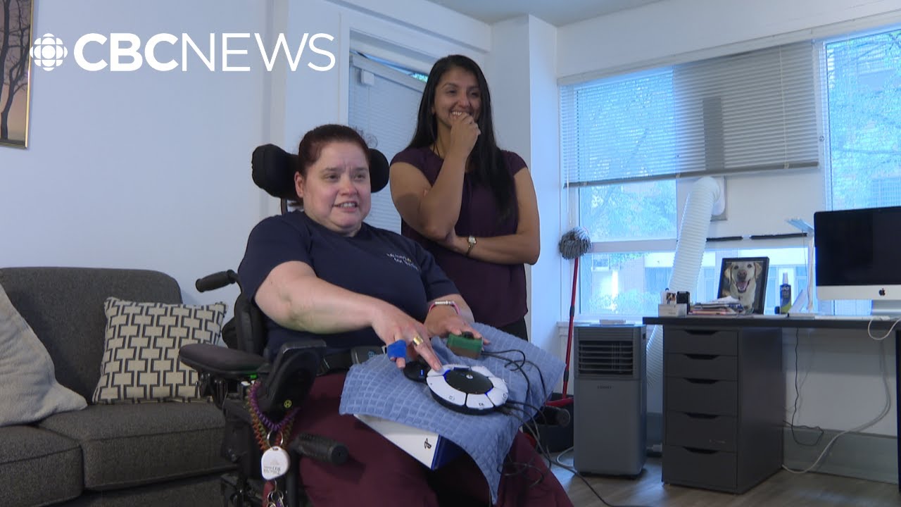 Pictured from the report: Gamers Club participant Nicole gaming using her setup as Denzil watches.