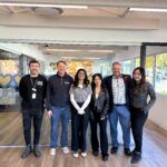Lukas, Justin, Anmol, Ashlyn, Nate, and Patty stand in the new facility.