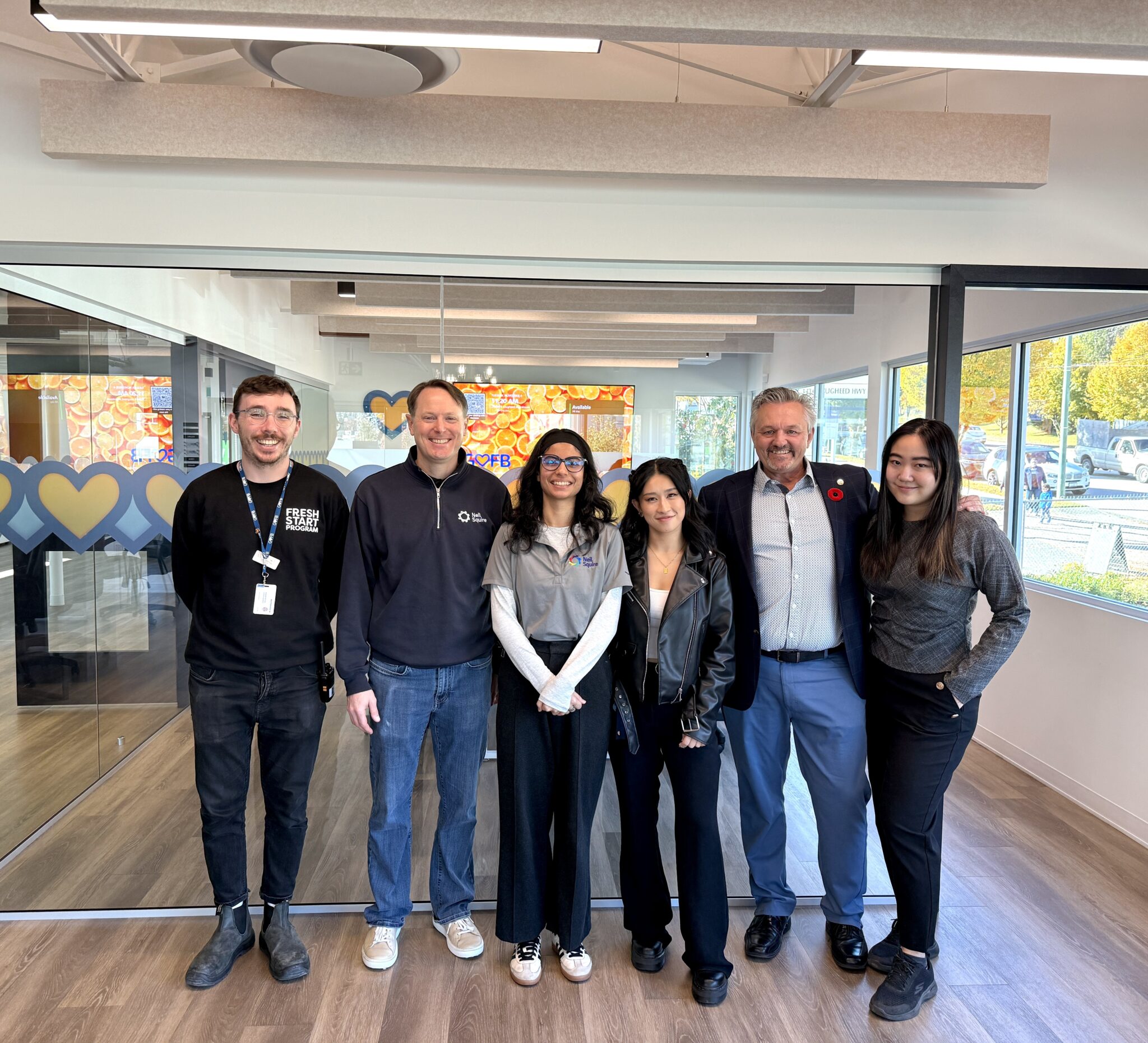 Lukas, Justin, Anmol, Ashlyn, Nate, and Patty stand in the new facility.