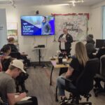 Neil Squire staff presenting to classroom full of people.