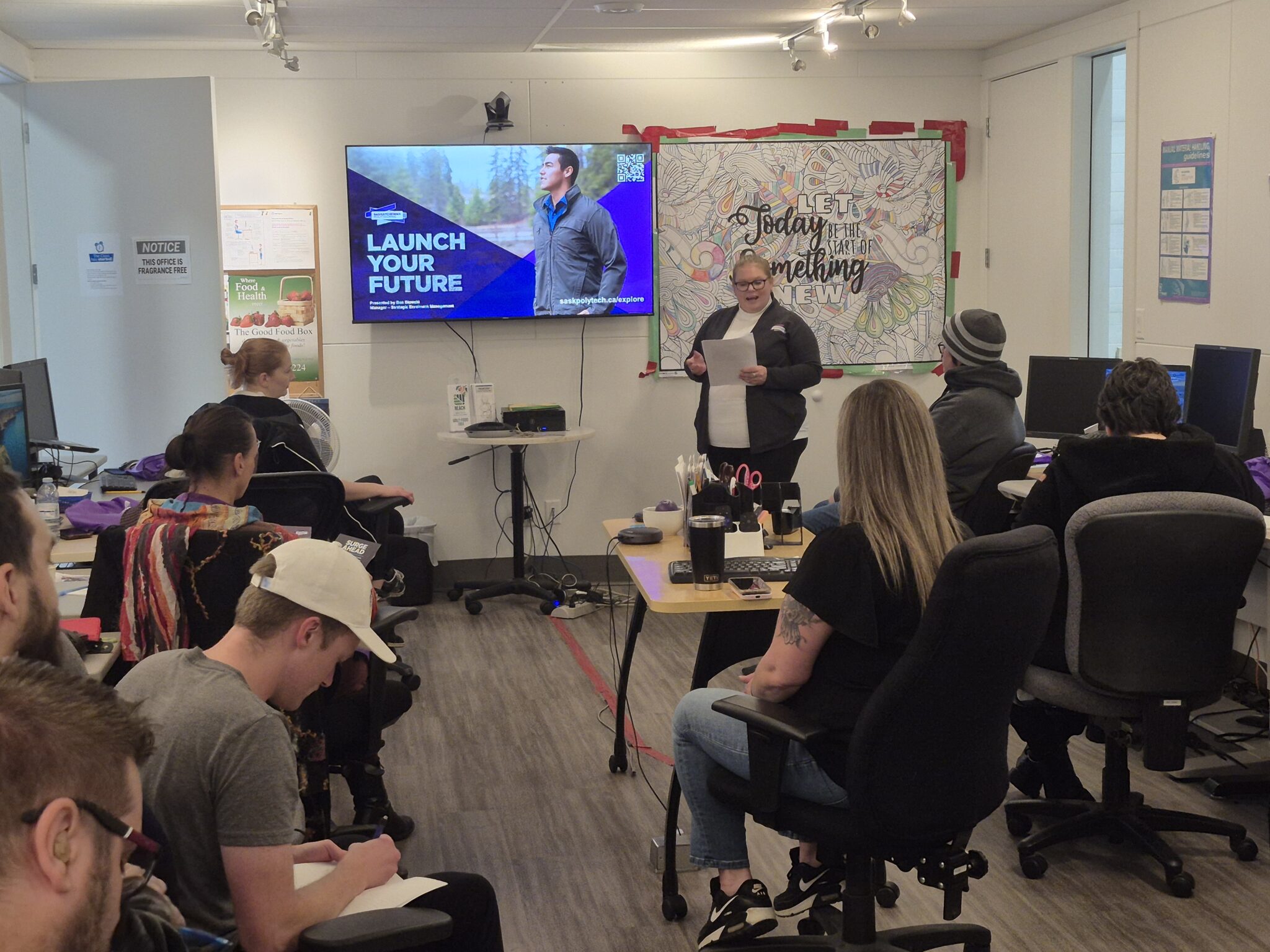 Neil Squire staff presenting to classroom full of people.