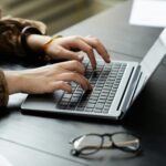 A person typing on a laptop.