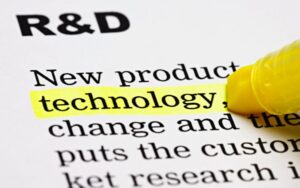 words on paper: R&D, new product, and the word technology is highlighted