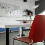 A chair at a desk facing a whiteboard in a classroom.