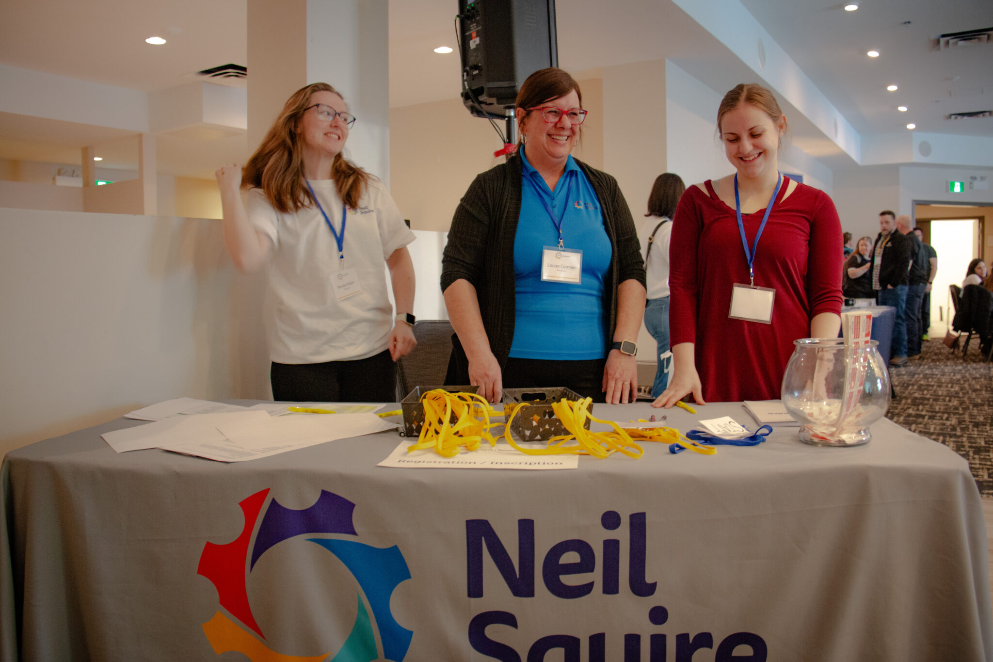 Neil Squire staff stand at the registration table helping guests check in.