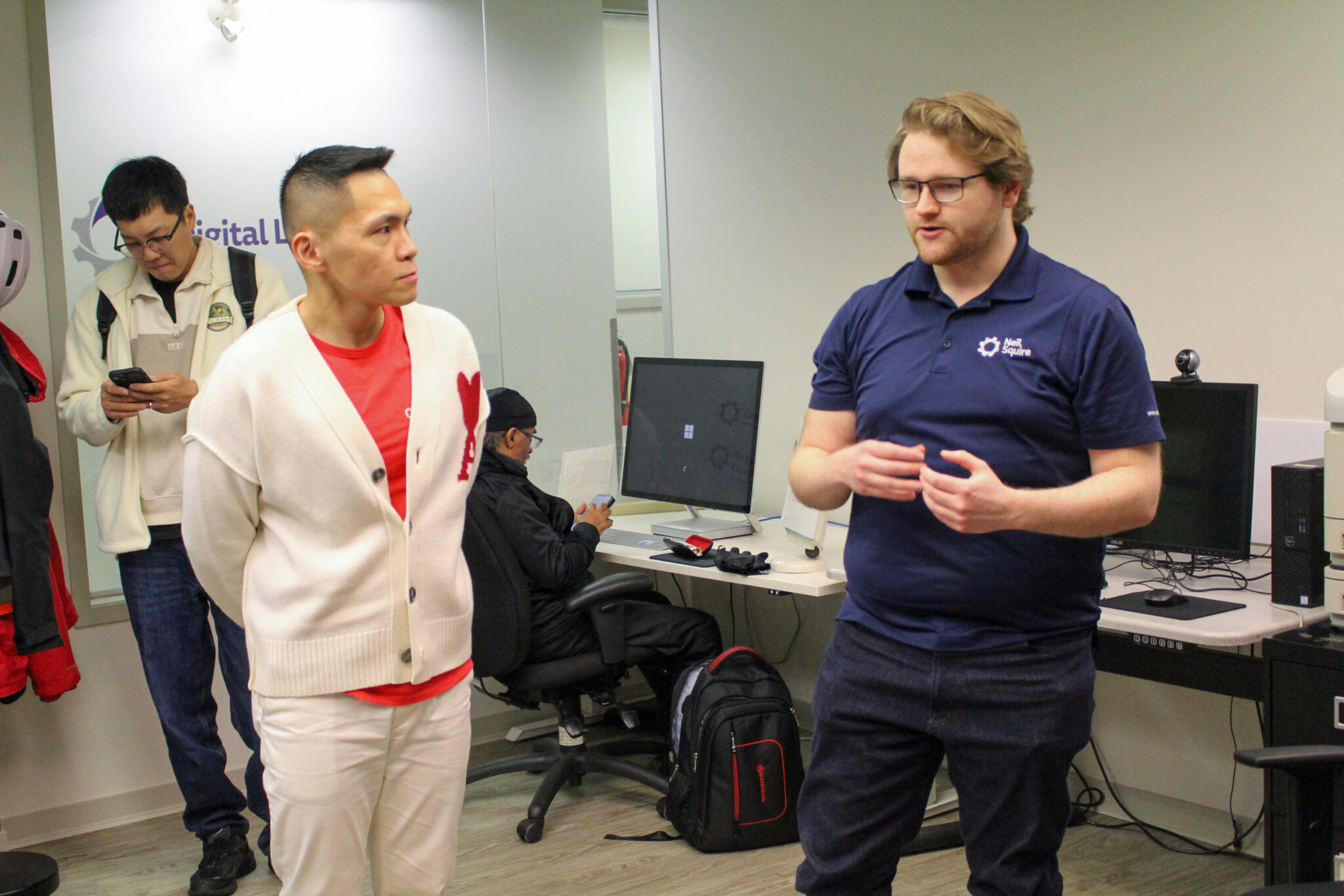 MP Wade Chang and Education Assistant and Computer Technician Curtis Larsen talk.