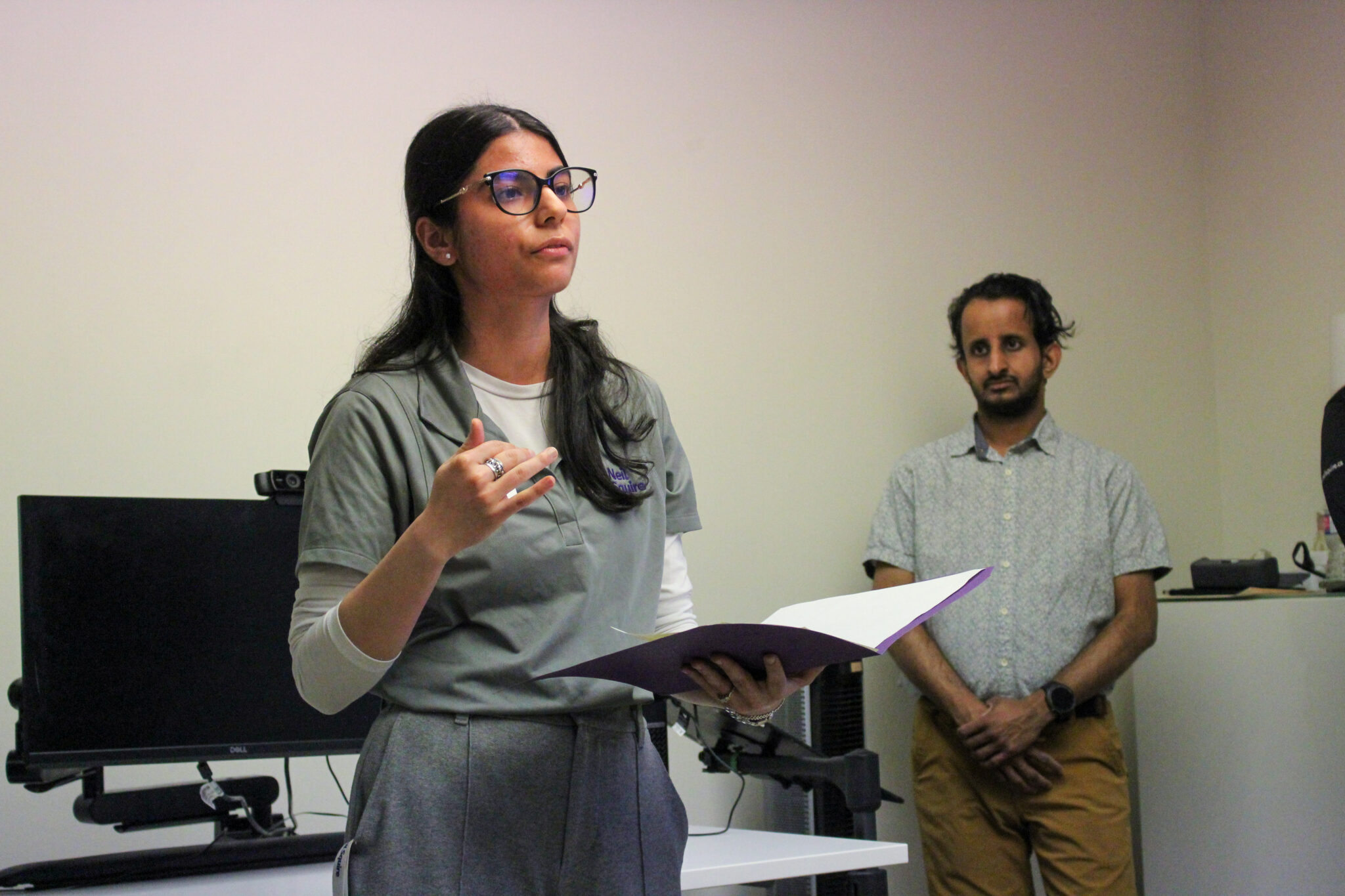 Creative Employment Options Case Manager Anmol Vig presents on the program as participant Narada looks on.
