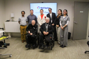Neil Squire staff, participants, and Wade Chang pose for a photo in the Solutions lab.