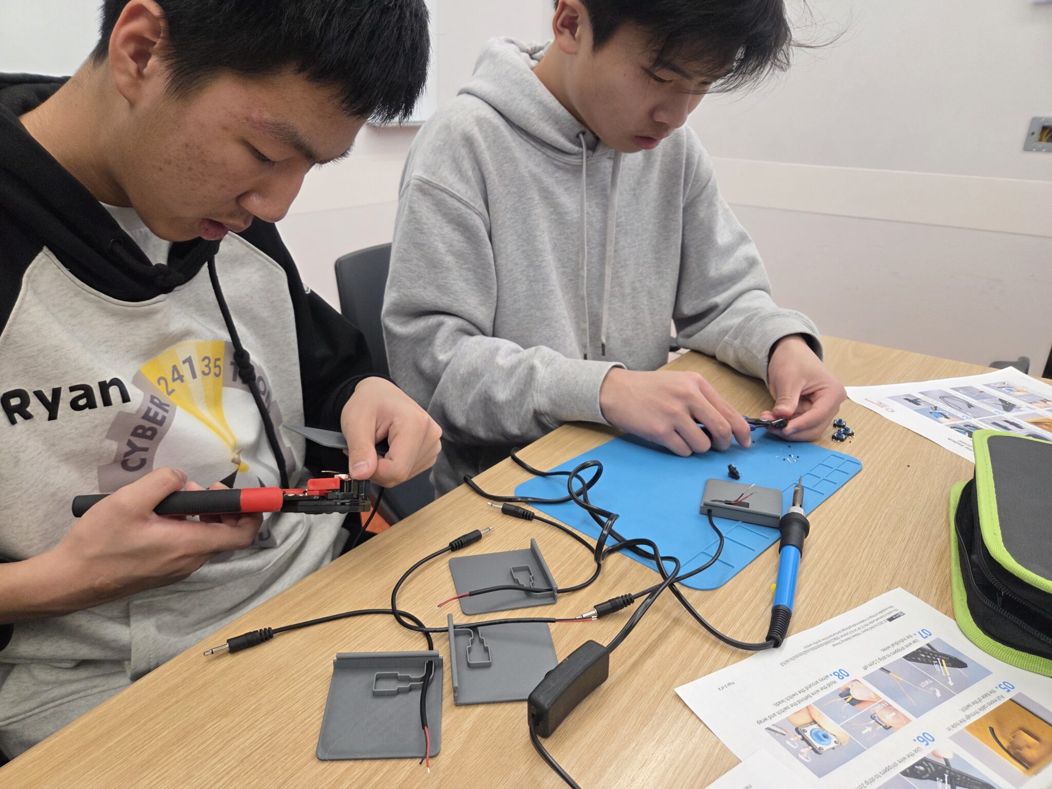 Two Cybertronic Penguinz club members building switches at a build event.