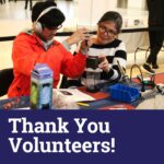 Two volunteers work on adapting a toy at a build event. Text: Thank you volunteers!