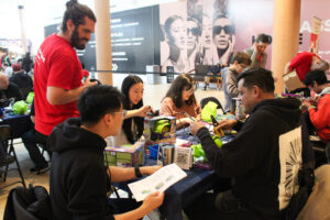 A group of volunteers sitting around a table at a build event