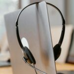 A headset resting on a laptop.