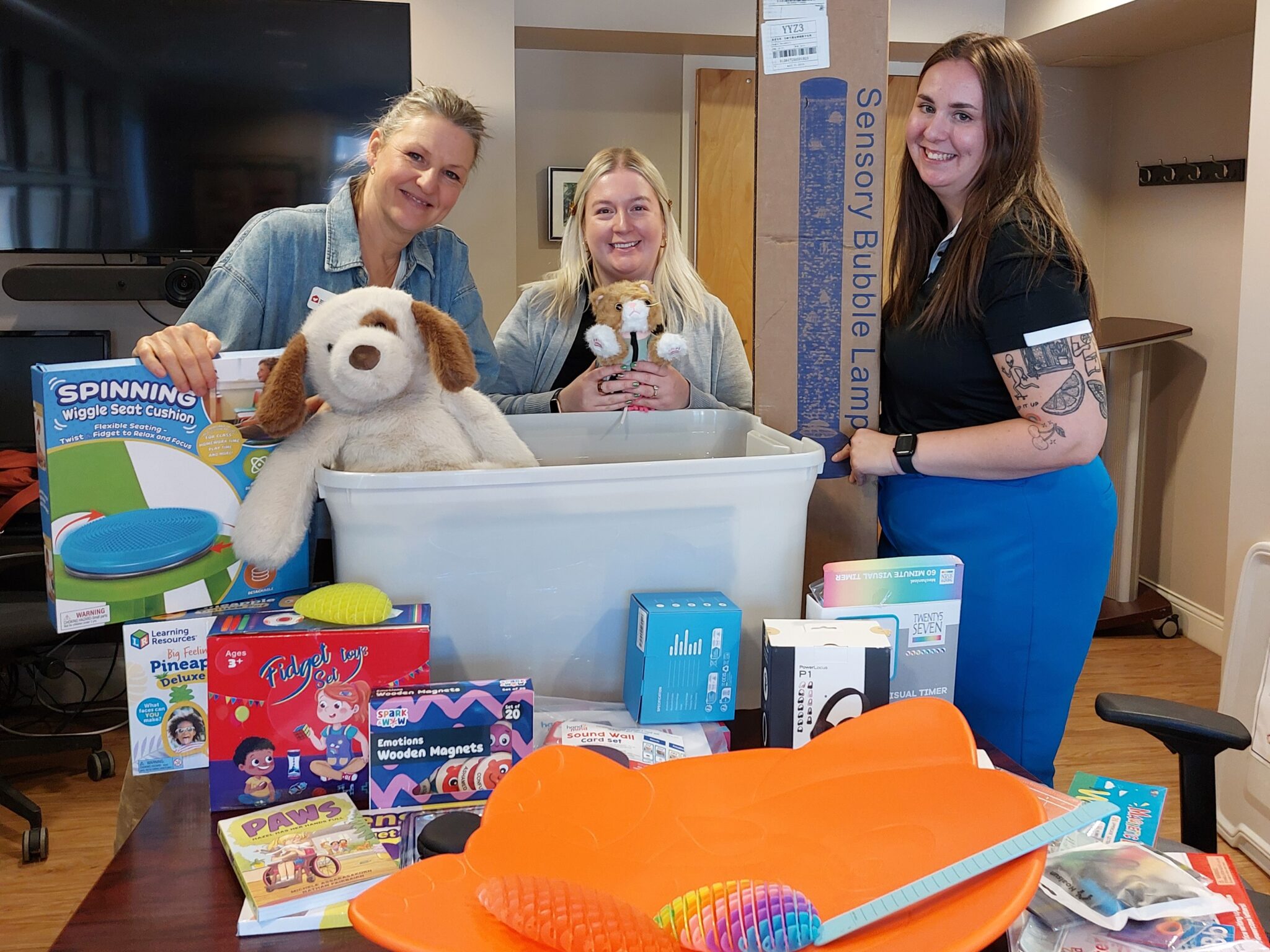 Chelsea, Amanda, and a clinician during a kit delivery.
