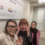 Linda, in between Joanna and Andleeb, poses for a photo in our Burnaby office.