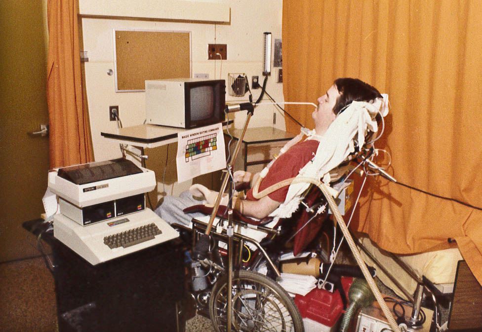 Neil Squire using a sip and puff device to use a computer.
