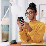 A woman uses a smartphone.