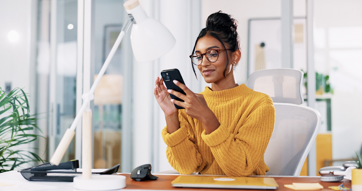 A woman uses a smartphone.