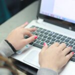 A woman works on a laptop.
