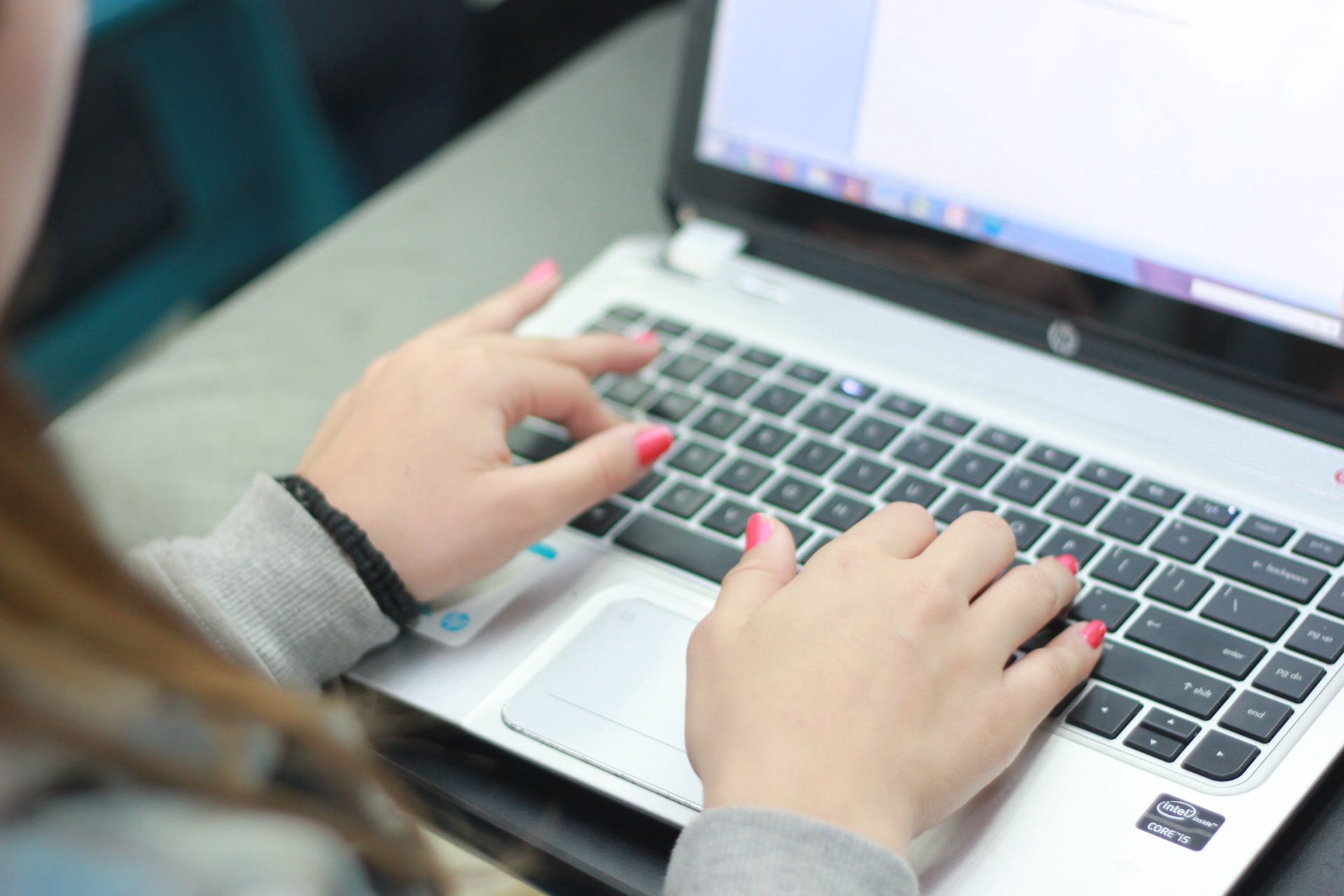 A woman works on a laptop.