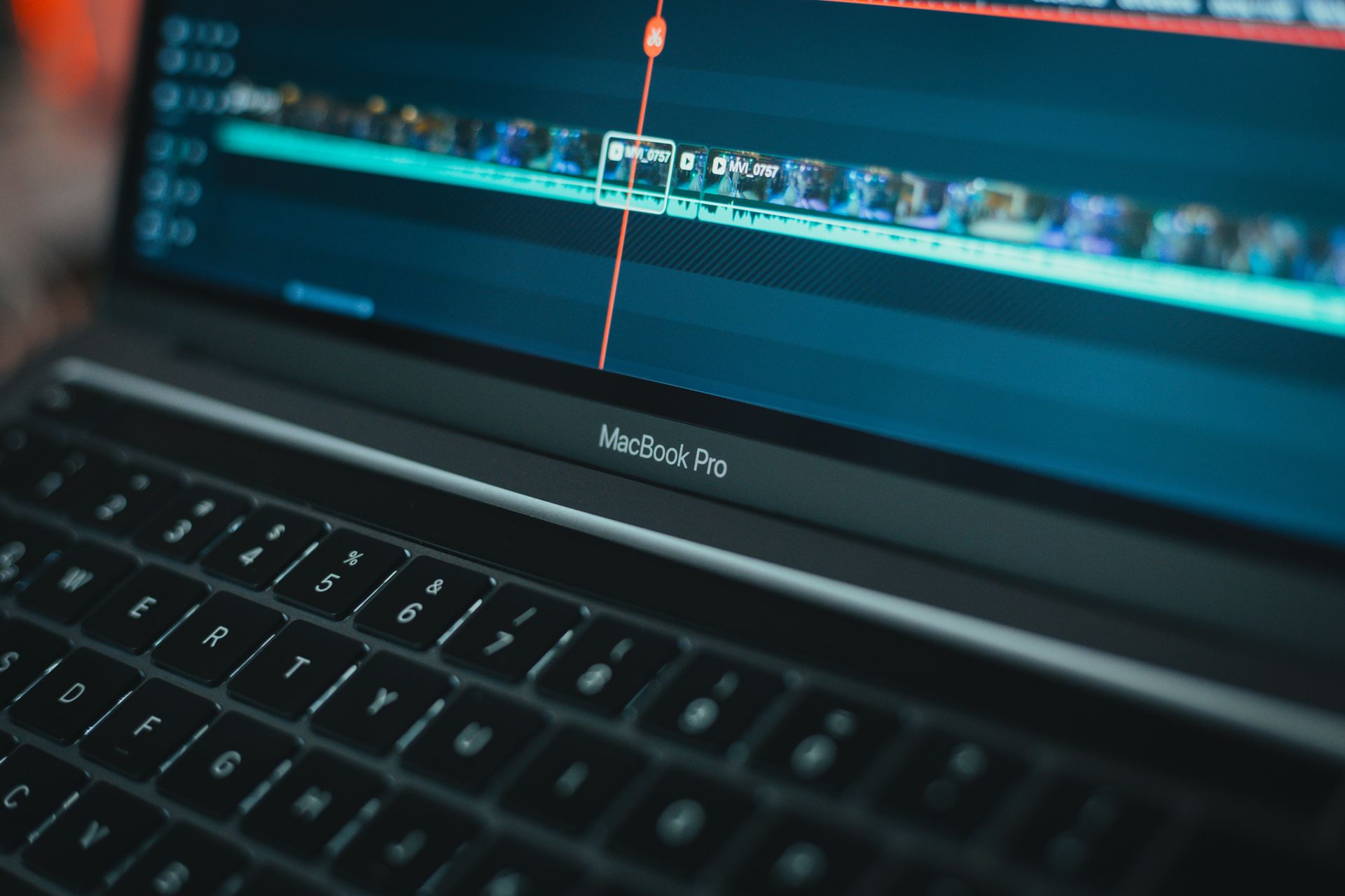 A person uses video editing software on their laptop.