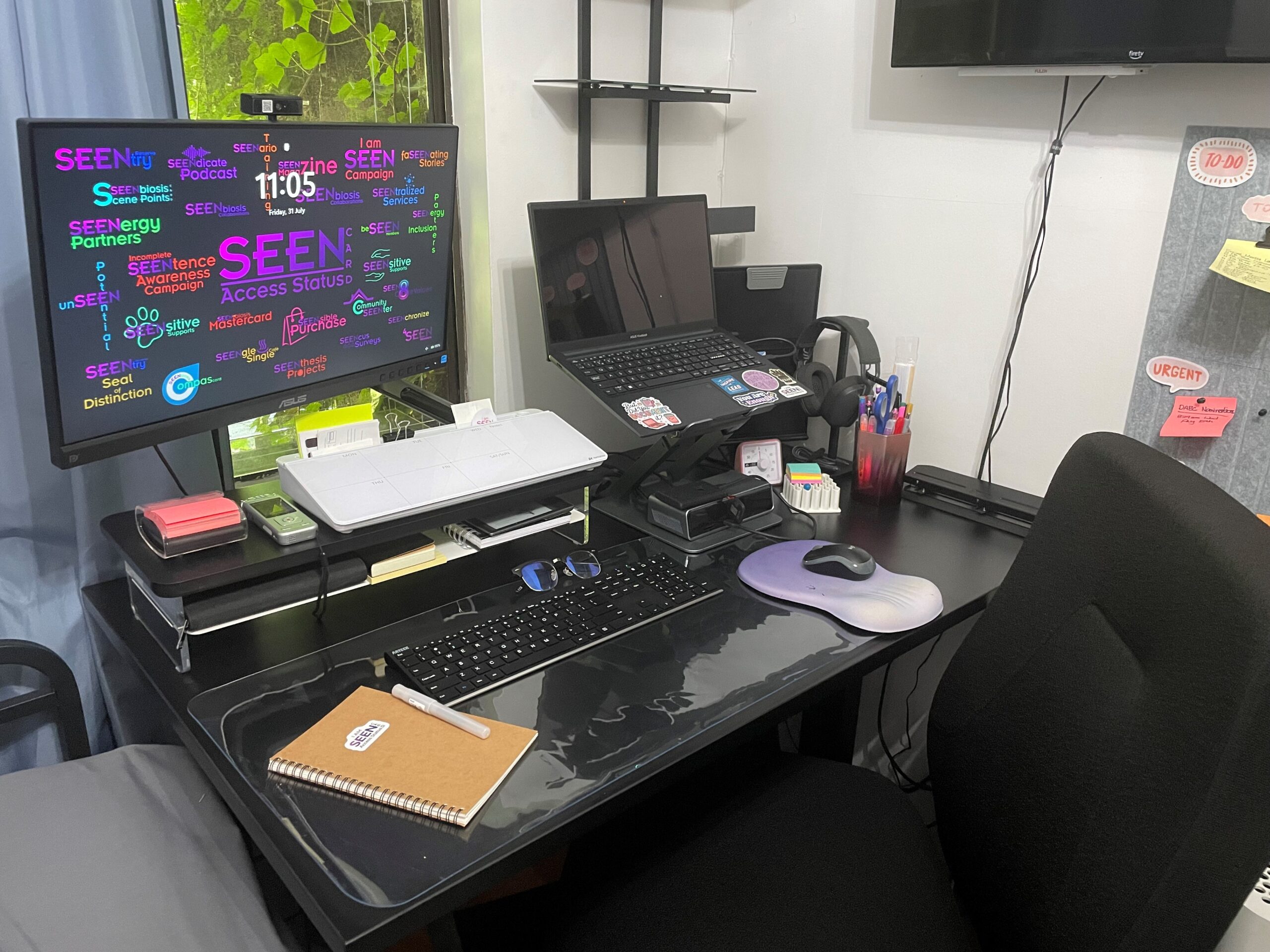 Kaysee's new home office setup with dual monitors, keyboard, mouse, and organized desk accessories.